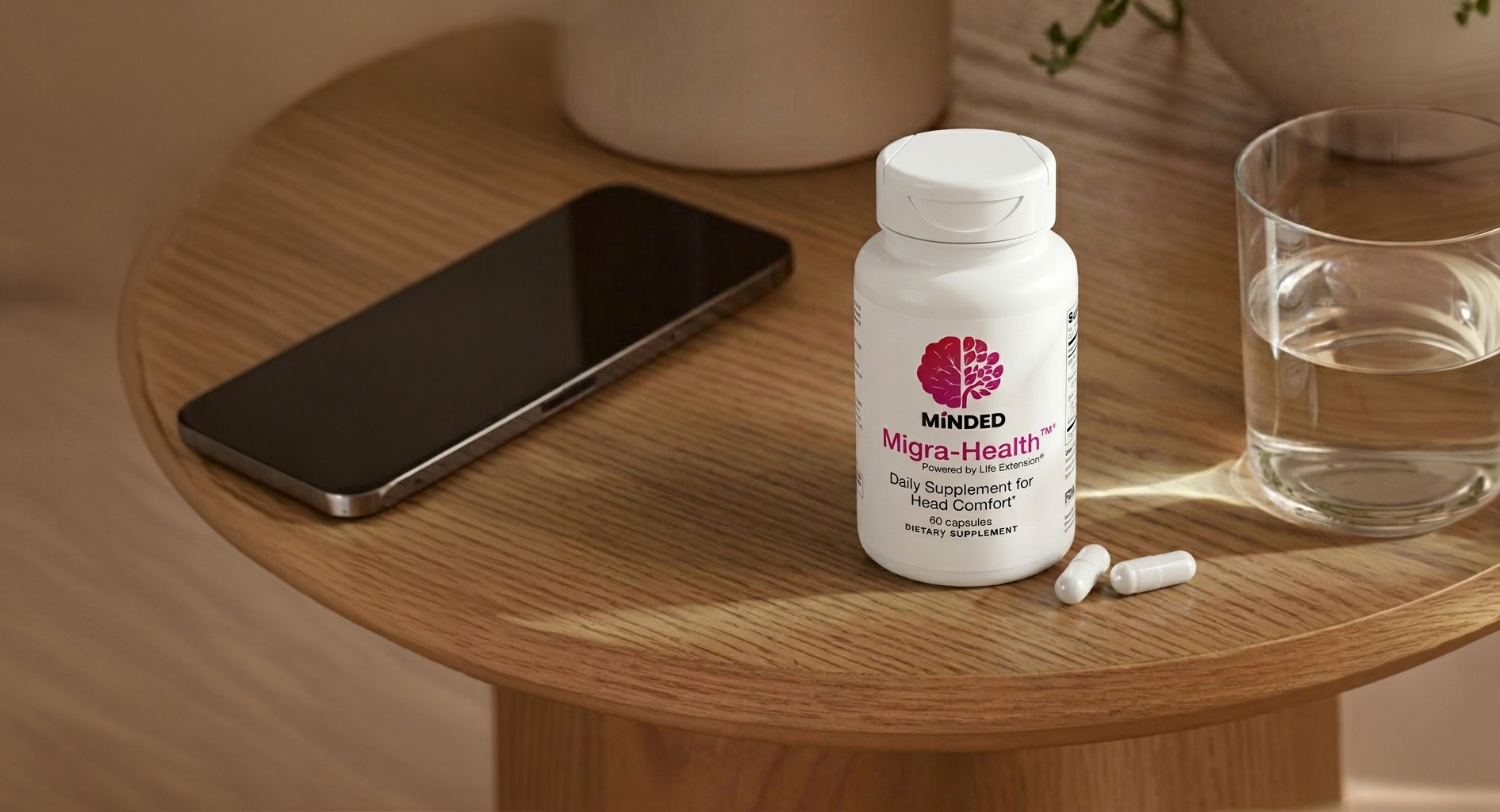 Phone on a nightstand beside a glass of water